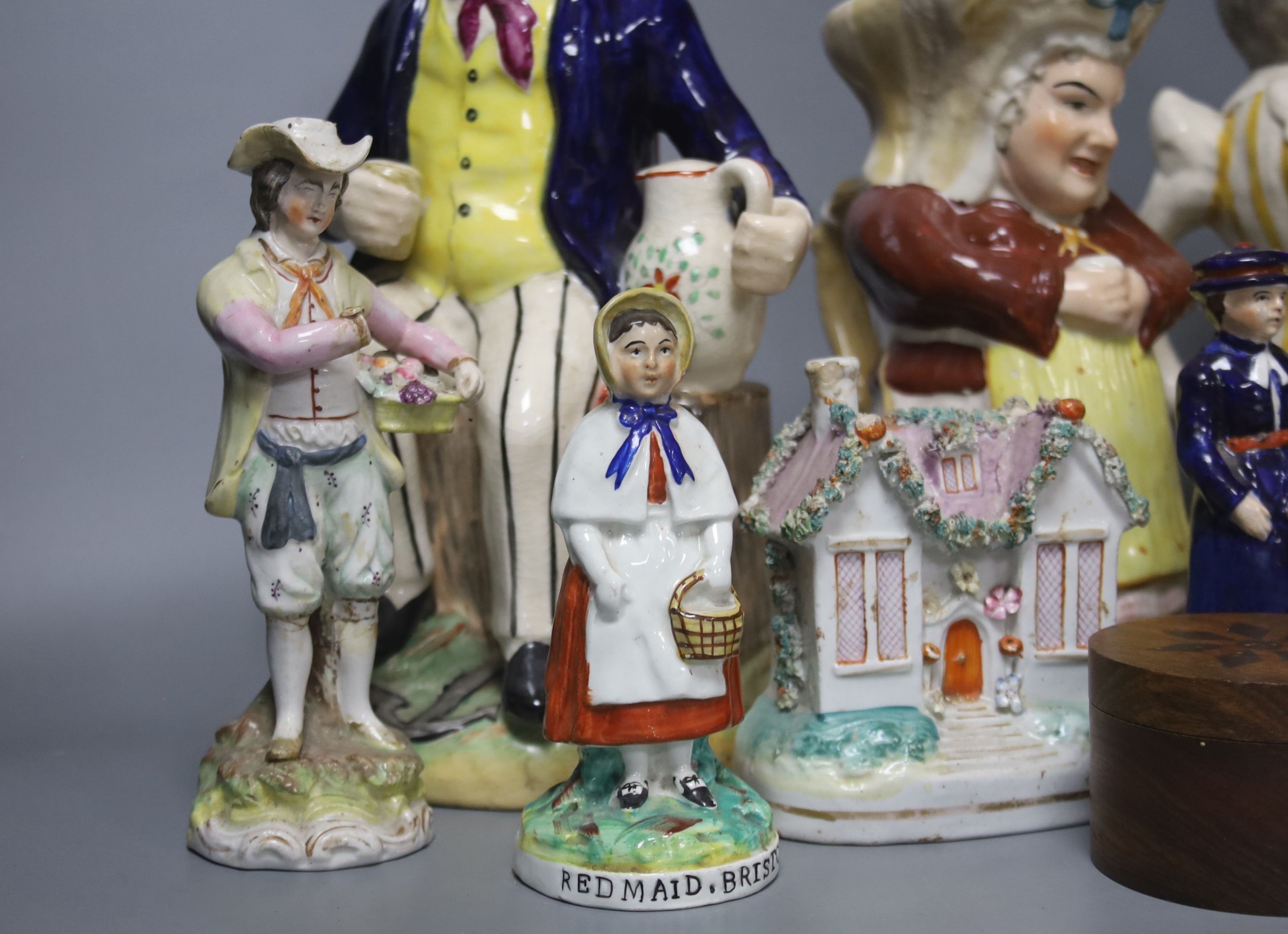 A group of assorted 19th century and later Staffordshire ceramics including a Toby jug, Colston Boy and Red Maid Girl Bristol
